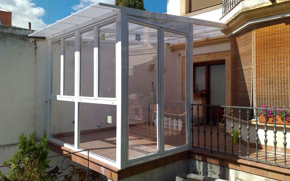 Cerramiento de terraza o porche de aluminio o PVC acristalado con tejadillo traslucido en Valladolid